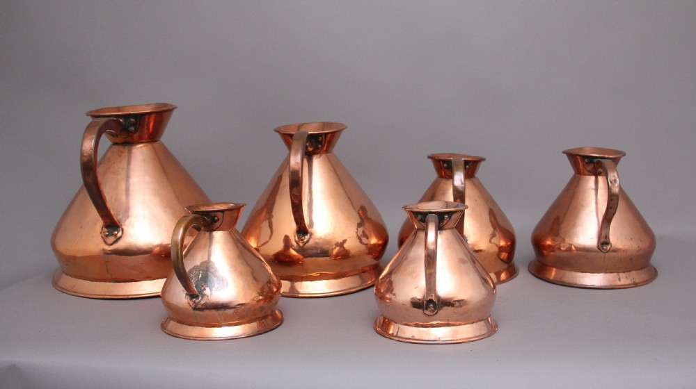 A set of six highly decorative 19th Century copper measuring jugs View III