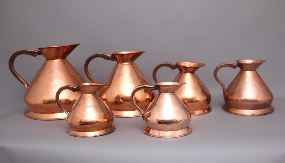 A set of six highly decorative 19th Century copper measuring jugs View IV