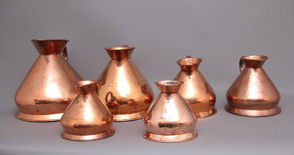 A set of six highly decorative 19th Century copper measuring jugs View V