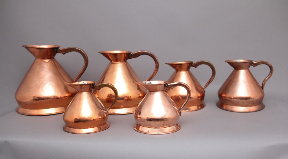 A set of six highly decorative 19th Century copper measuring jugs View VI