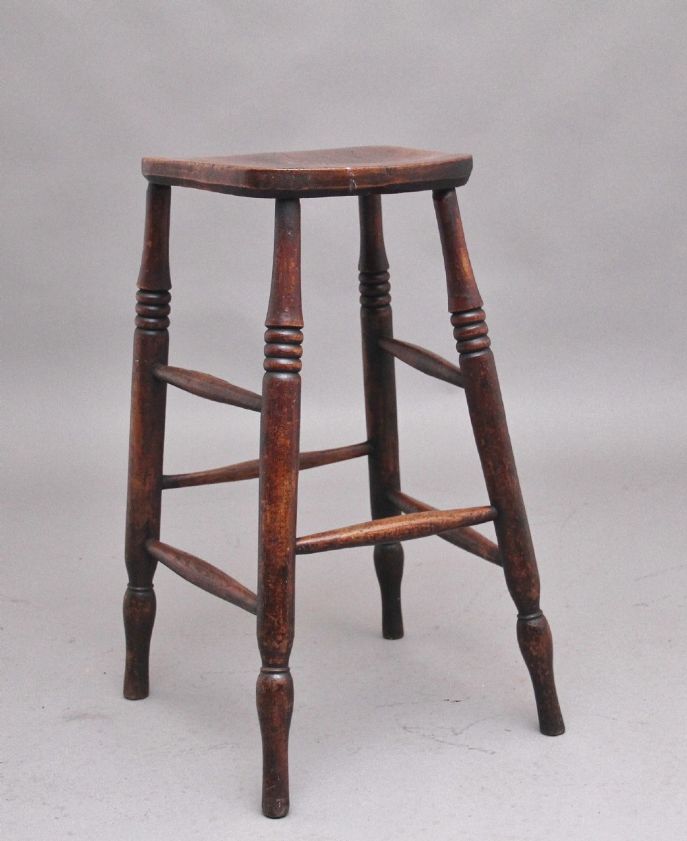 A tall mid 19th Century ash and elm stool