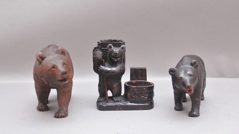 A set of three nineteenth-century hand-carved dark wood Black Forest bear figures, including two standing bears and one central desk accessory bear. View II