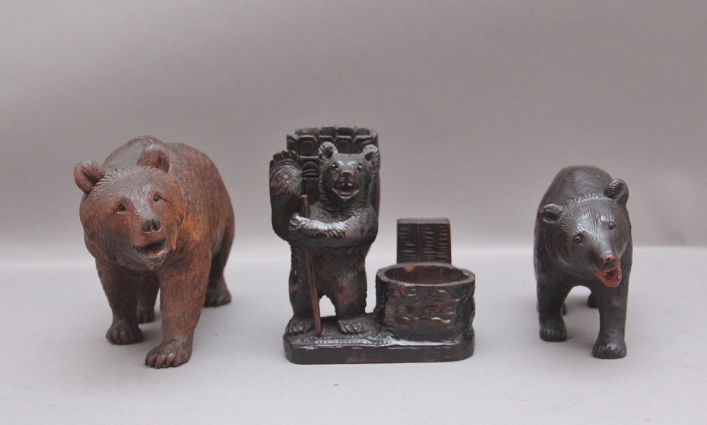A set of three nineteenth-century hand-carved dark wood Black Forest bear figures, including two standing bears and one central desk accessory bear. View III