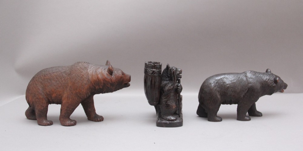 A set of three nineteenth-century hand-carved dark wood Black Forest bear figures, including two standing bears and one central desk accessory bear. View IV