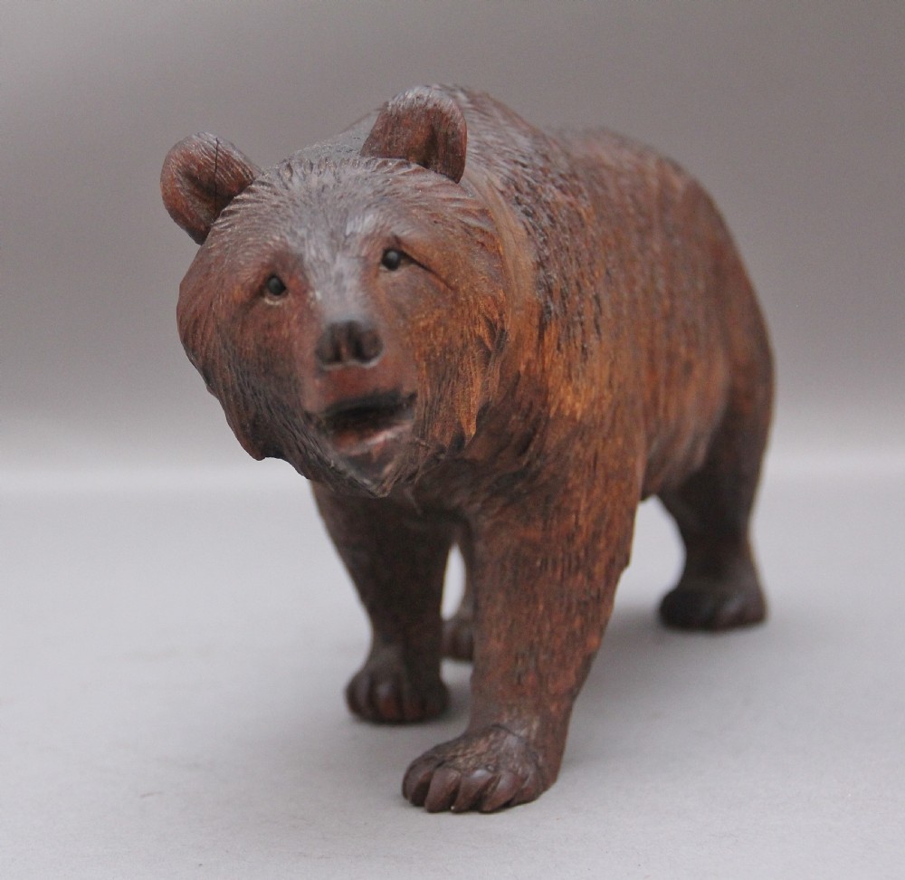 A set of three nineteenth-century hand-carved dark wood Black Forest bear figures, including two standing bears and one central desk accessory bear. View VII