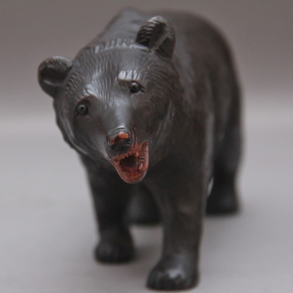 A set of three nineteenth-century hand-carved dark wood Black Forest bear figures, including two standing bears and one central desk accessory bear. View VIII