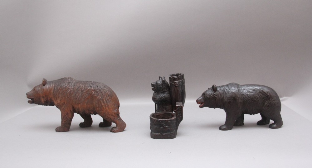 A set of three nineteenth-century hand-carved dark wood Black Forest bear figures, including two standing bears and one central desk accessory bear. View IX