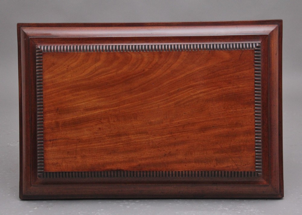 A 19th-century mahogany cellarette of sarcophagus form featuring a stepped lid, panelled sides, and carved gadrooned feet with castors. View IV