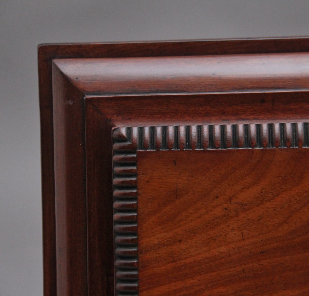 A 19th-century mahogany cellarette of sarcophagus form featuring a stepped lid, panelled sides, and carved gadrooned feet with castors. View V