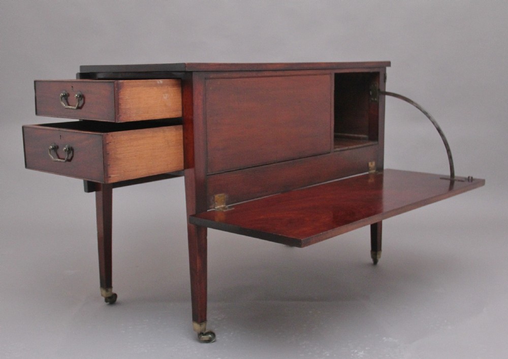 An 18th-century mahogany drop-leaf side table featuring two end drawers with brass bail handles and square tapered legs ending in brass castors. View III