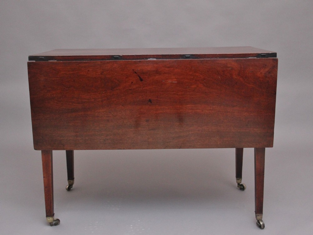 An 18th-century mahogany drop-leaf side table featuring two end drawers with brass bail handles and square tapered legs ending in brass castors. View V