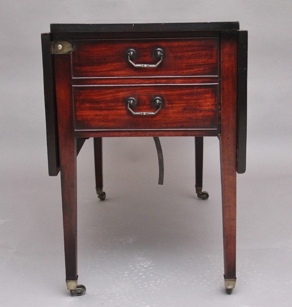 An 18th-century mahogany drop-leaf side table featuring two end drawers with brass bail handles and square tapered legs ending in brass castors. View VI