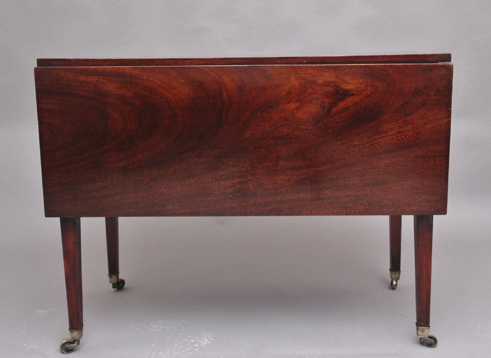 An 18th-century mahogany drop-leaf side table featuring two end drawers with brass bail handles and square tapered legs ending in brass castors. View VII