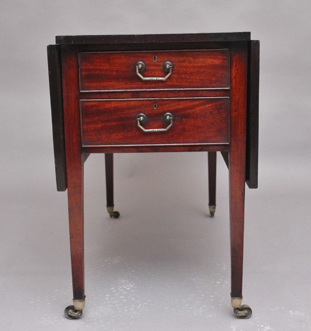 An 18th-century mahogany drop-leaf side table featuring two end drawers with brass bail handles and square tapered legs ending in brass castors. View VIII