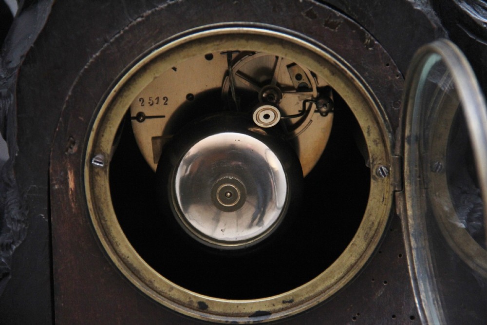 A 19th-century carved dark wood Black Forest mantel clock featuring a cockerel finial, foliage motifs, and a central circular clock face with Roman numerals. View XIII