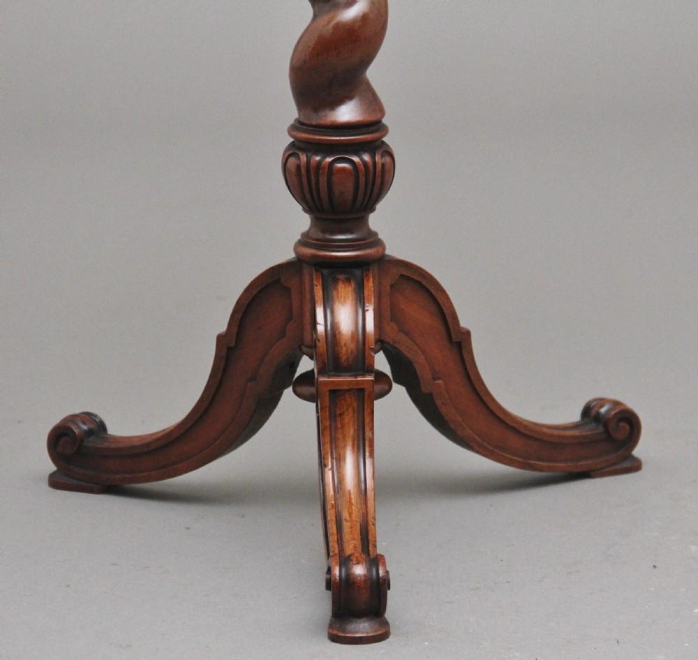 A 19th-century Victorian walnut wine table featuring a circular top, a barley twist column, and a carved tripod base with scroll feet. View VII