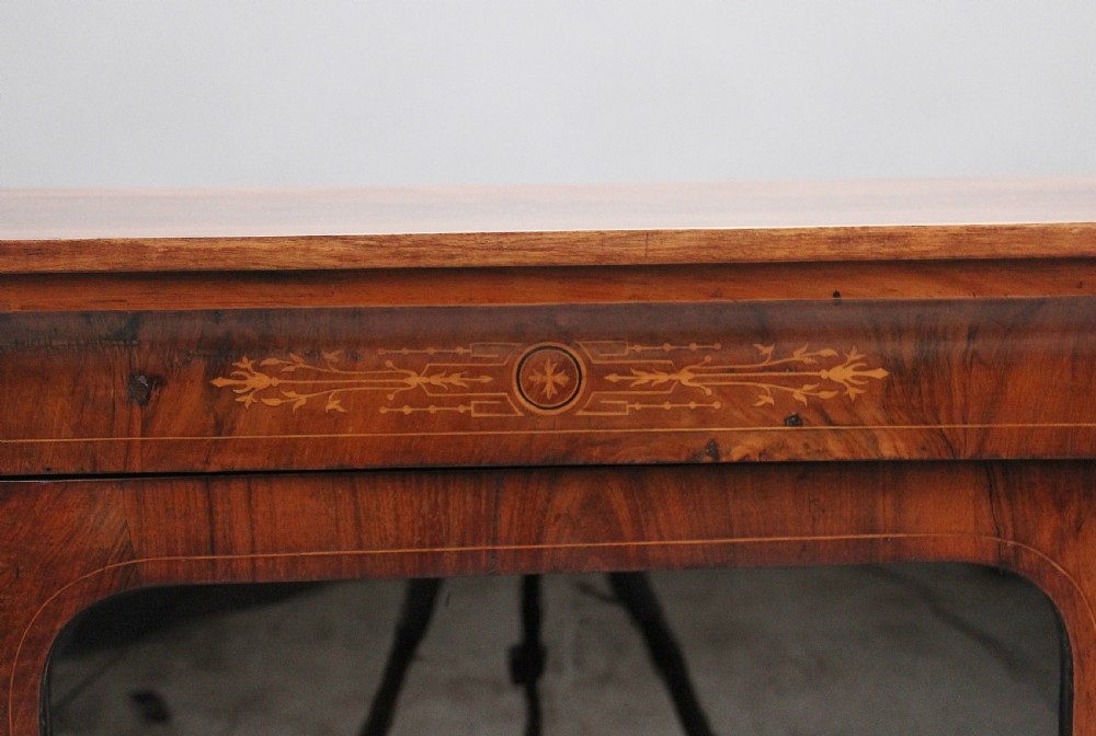 A 19th-century walnut pier cabinet featuring floral marquetry inlays, decorative brass mounts, and a single glazed door revealing fitted shelves. View X