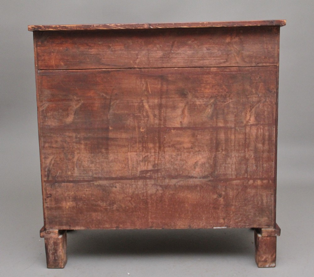An early nineteenth-century flame mahogany bowfront chest featuring four graduated drawers with inlaid banding and brass handles. View VI