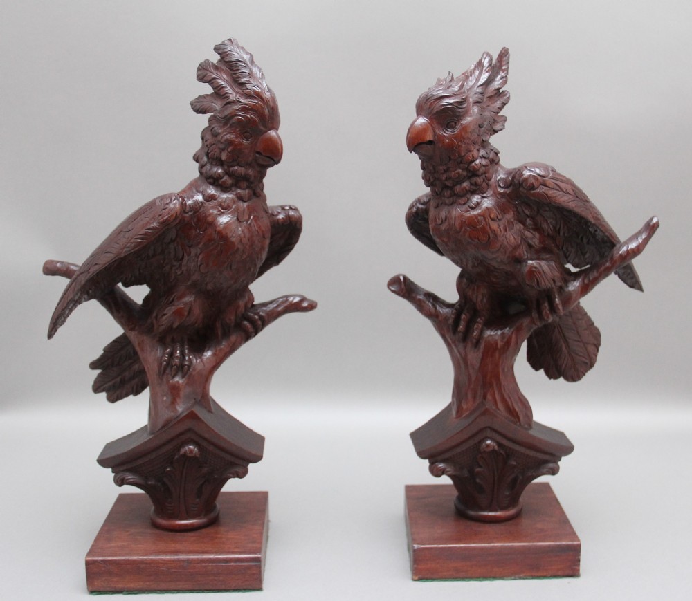 A pair of decorative 19th Century carved walnut parakeets 