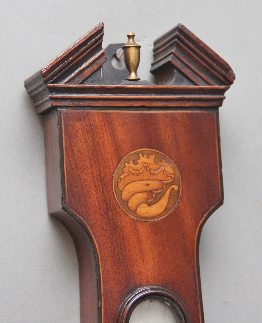 A 19th-century mahogany banjo barometer featuring shell marquetry inlays, a thermometer housing, a broken arch pediment, and a silvered dial. View III