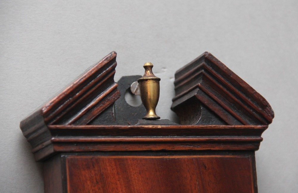 A 19th-century mahogany banjo barometer featuring shell marquetry inlays, a thermometer housing, a broken arch pediment, and a silvered dial. View VI