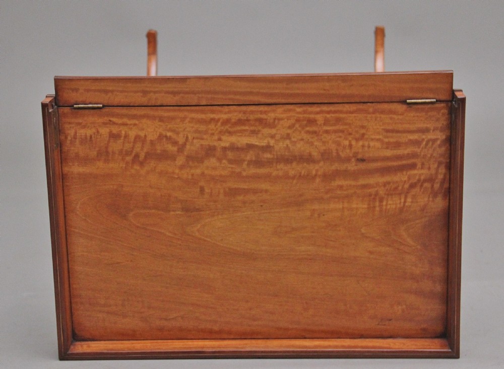 A 19th-century Sheraton Revival satinwood serving table featuring a tray top, pierced side supports, a lower shelf, and splayed legs on brass castors. View VII
