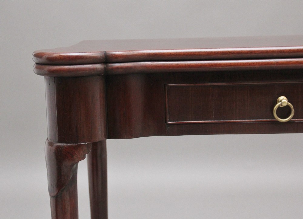 A mid-18th-century mahogany card table featuring a fold-over top, a single frieze drawer with a brass ring handle, and cabriole legs with pad feet. View II