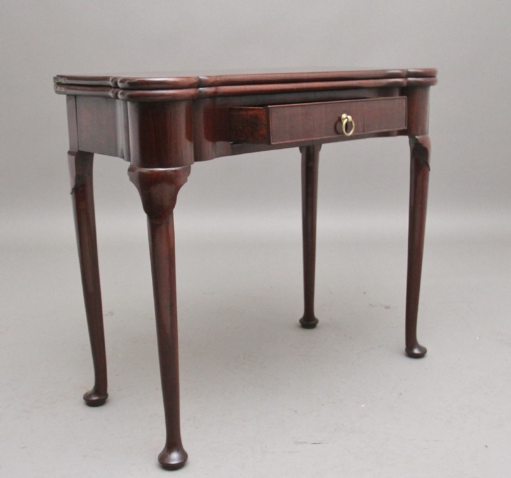 A mid-18th-century mahogany card table featuring a fold-over top, a single frieze drawer with a brass ring handle, and cabriole legs with pad feet. View IV