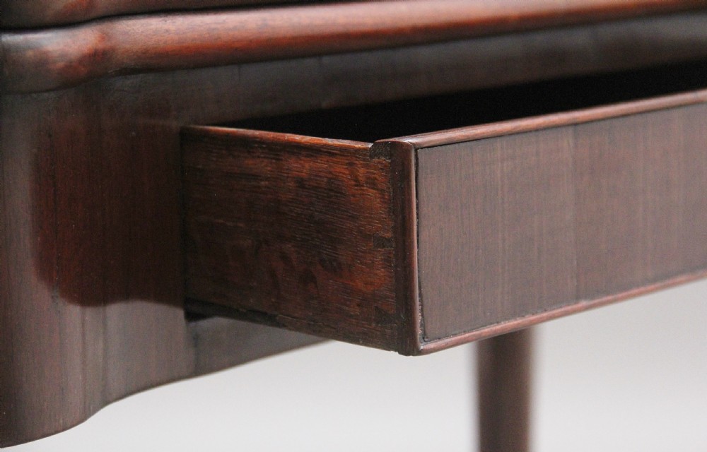 A mid-18th-century mahogany card table featuring a fold-over top, a single frieze drawer with a brass ring handle, and cabriole legs with pad feet. View V