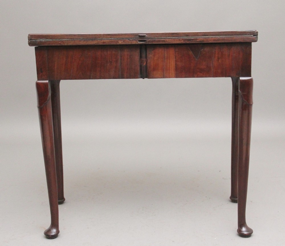 A mid-18th-century mahogany card table featuring a fold-over top, a single frieze drawer with a brass ring handle, and cabriole legs with pad feet. View VII