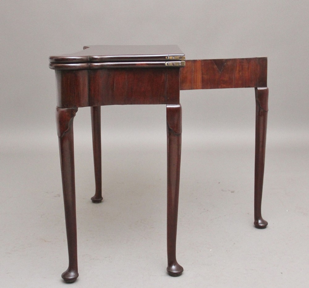 A mid-18th-century mahogany card table featuring a fold-over top, a single frieze drawer with a brass ring handle, and cabriole legs with pad feet. View IX