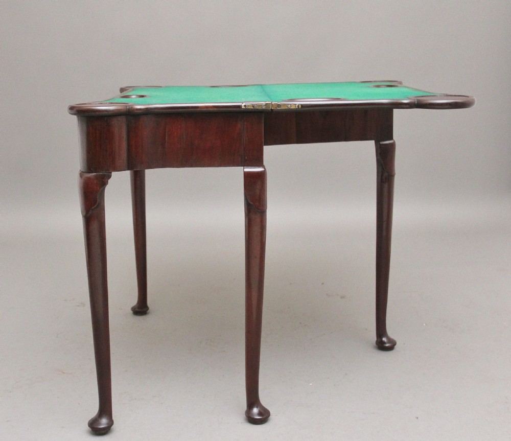 A mid-18th-century mahogany card table featuring a fold-over top, a single frieze drawer with a brass ring handle, and cabriole legs with pad feet. View X