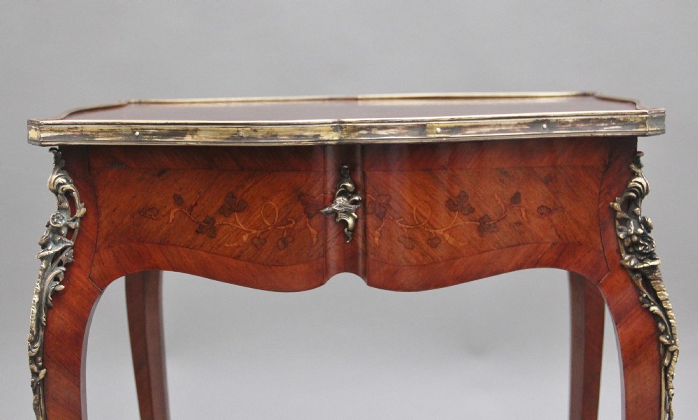 A 19th-century French kingwood side table featuring floral marquetry inlay, slender cabriole legs, and ornate gilt-metal mounts. View IX