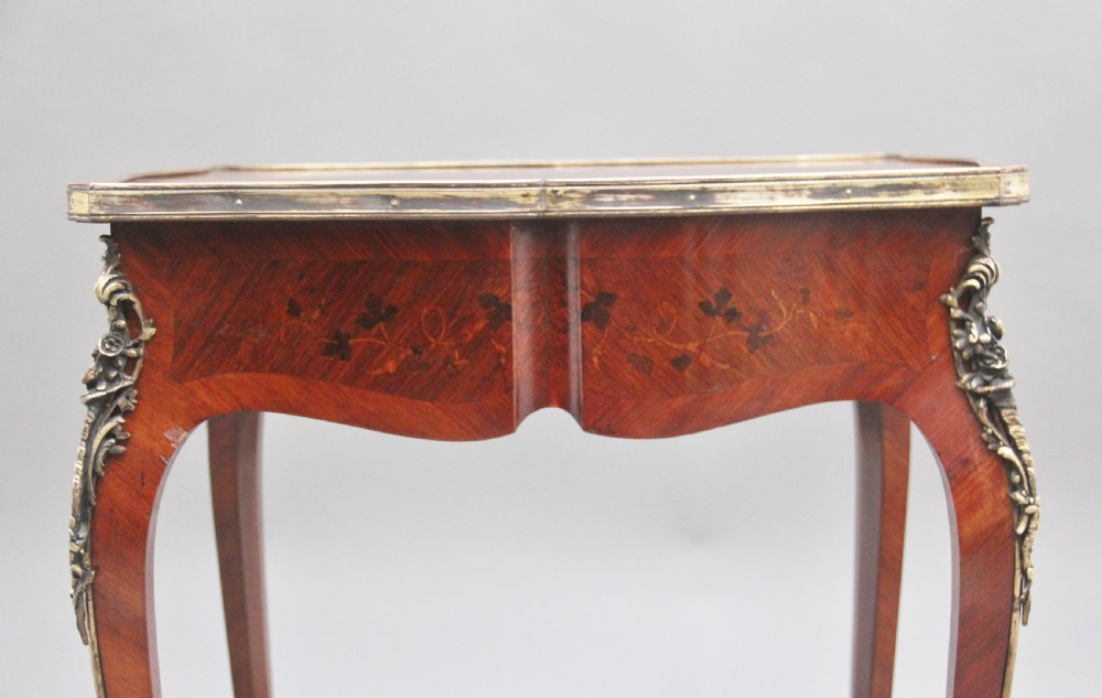 A 19th-century French kingwood side table featuring floral marquetry inlay, slender cabriole legs, and ornate gilt-metal mounts. View X