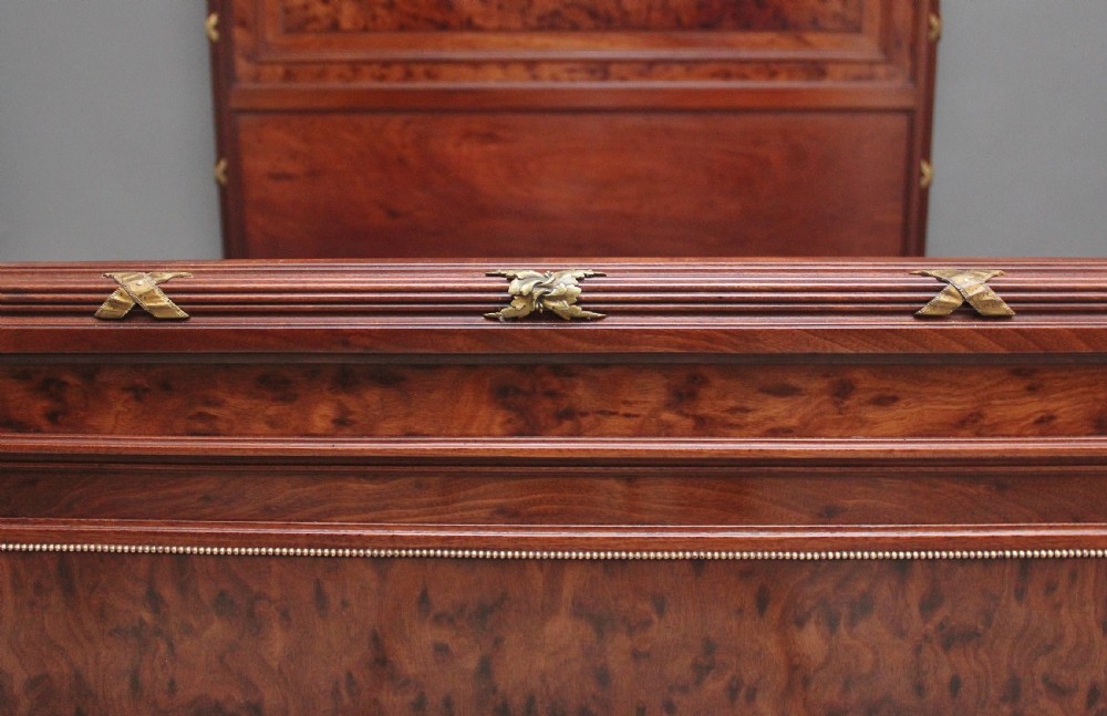 A 19th-century French Neoclassical bed frame crafted from dark mottled mahogany featuring decorative brass scroll mounts and a carved central medallion. View XI