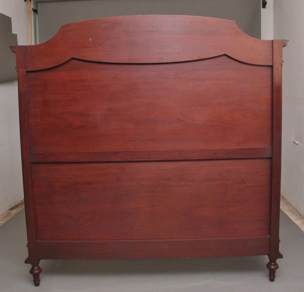 A 19th-century French Neoclassical bed frame crafted from dark mottled mahogany featuring decorative brass scroll mounts and a carved central medallion. View XIV