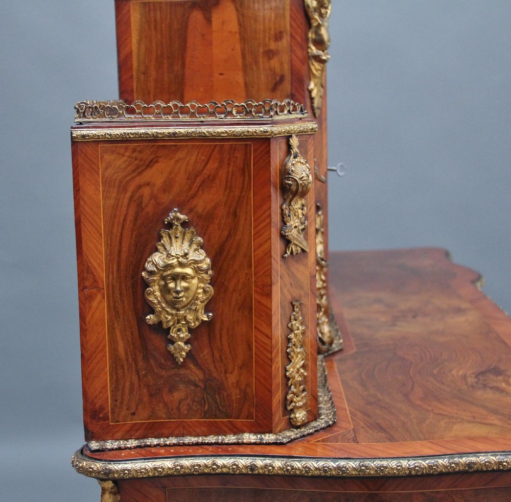 A 19th-century walnut writing desk featuring ornamental gilt-bronze mounts, cabriole legs, and a raised central glazed cabinet flanked by drawers. View VIII
