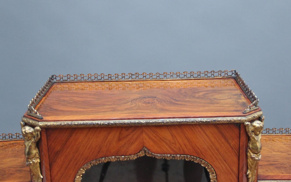A 19th-century walnut writing desk featuring ornamental gilt-bronze mounts, cabriole legs, and a raised central glazed cabinet flanked by drawers. View XVII