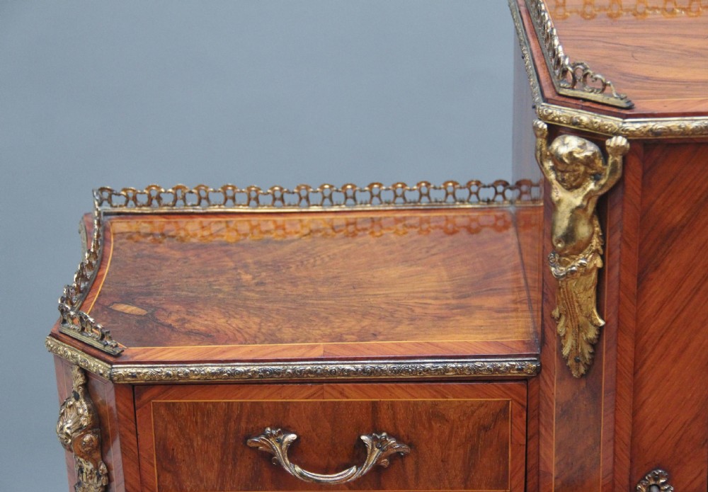 A 19th-century walnut writing desk featuring ornamental gilt-bronze mounts, cabriole legs, and a raised central glazed cabinet flanked by drawers. View XVIII