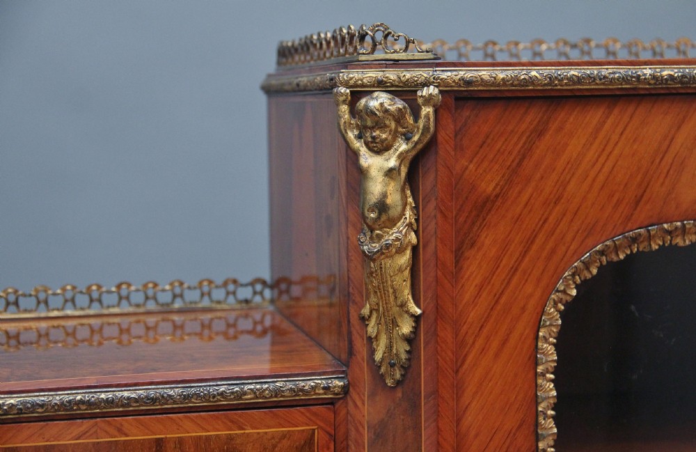 A 19th-century walnut writing desk featuring ornamental gilt-bronze mounts, cabriole legs, and a raised central glazed cabinet flanked by drawers. View XX