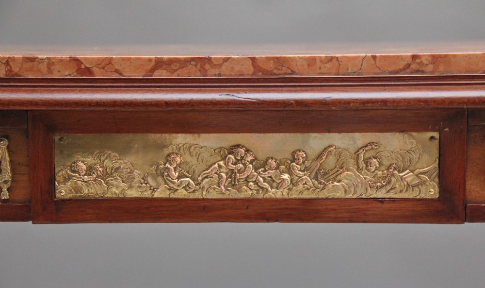 A 19th-century French mahogany centre table featuring a pink marble top, slender tapered legs, and decorative gilt-bronze mounts with swags and cherub relief. View XII