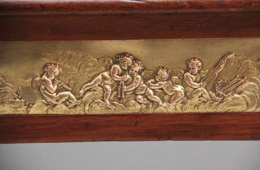 A 19th-century French mahogany centre table featuring a pink marble top, slender tapered legs, and decorative gilt-bronze mounts with swags and cherub relief. View XIII