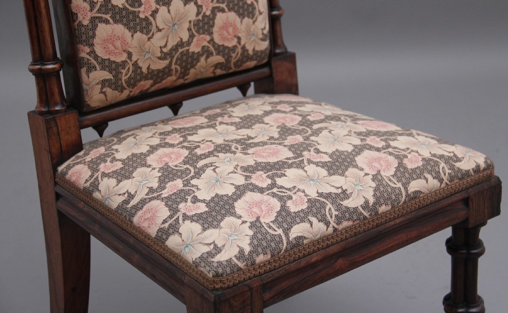 An early 19th-century Gothic Revival rosewood side chair featuring a tall upholstered back, floral pattern fabric, and clustered column turned legs. View VIII