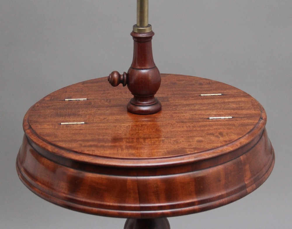A 19th-century mahogany telescopic shaving mirror featuring a circular adjustable mirror mounted on a brass rod above a small round tray surface and carved tripod legs. View V