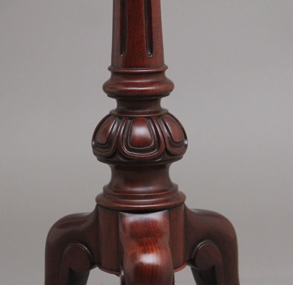 A 19th-century mahogany telescopic shaving mirror featuring a circular adjustable mirror mounted on a brass rod above a small round tray surface and carved tripod legs. View IX