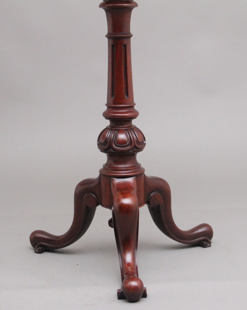 A 19th-century mahogany telescopic shaving mirror featuring a circular adjustable mirror mounted on a brass rod above a small round tray surface and carved tripod legs. View X