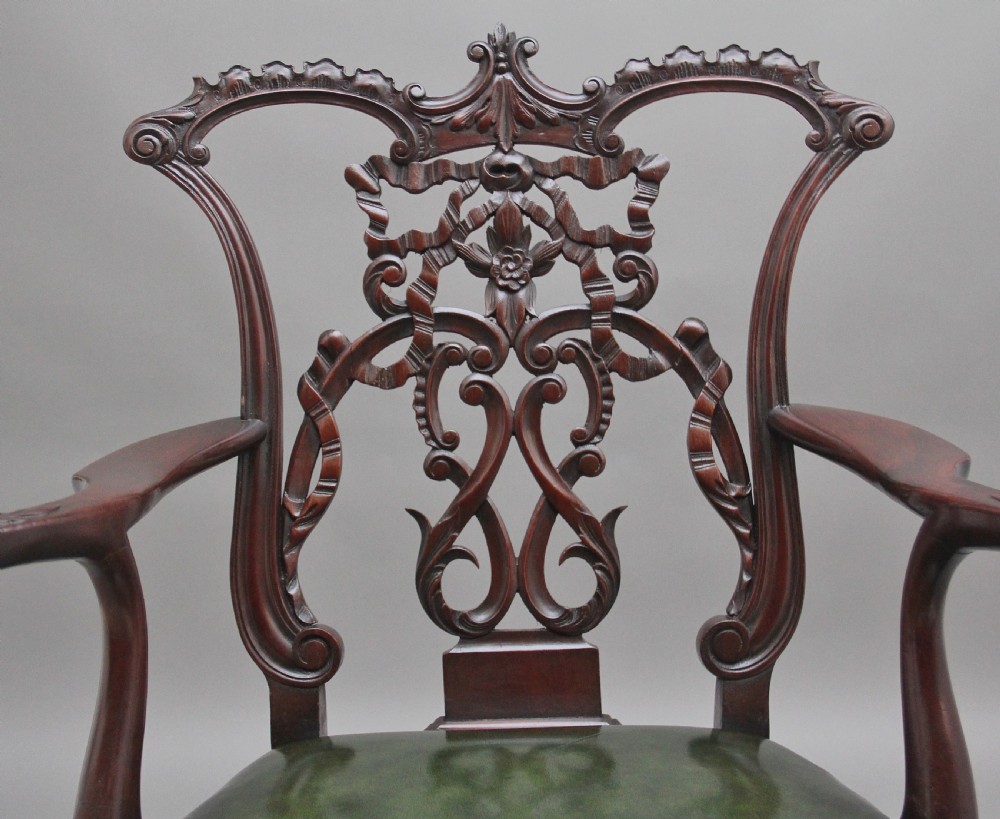 An early 20th-century Chippendale style mahogany armchair featuring a detailed pierced back splat, green leather upholstered seat with brass studding, curved armrests, and cabriole front legs terminating in claw and ball feet. View VII
