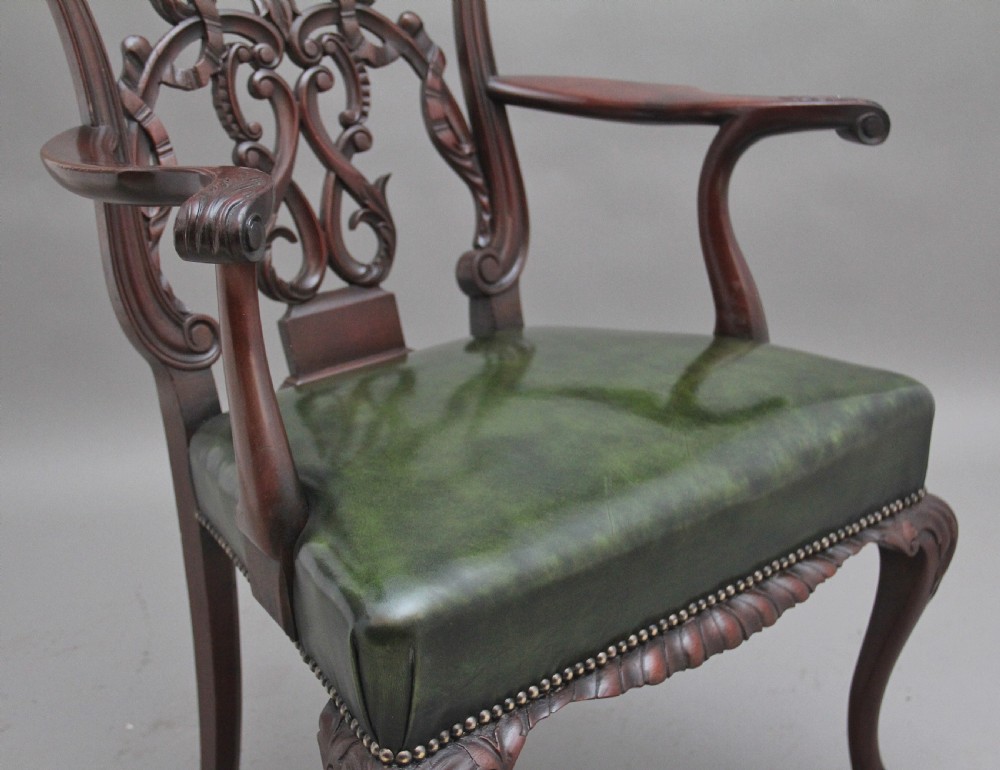 An early 20th-century Chippendale style mahogany armchair featuring a detailed pierced back splat, green leather upholstered seat with brass studding, curved armrests, and cabriole front legs terminating in claw and ball feet. View IX