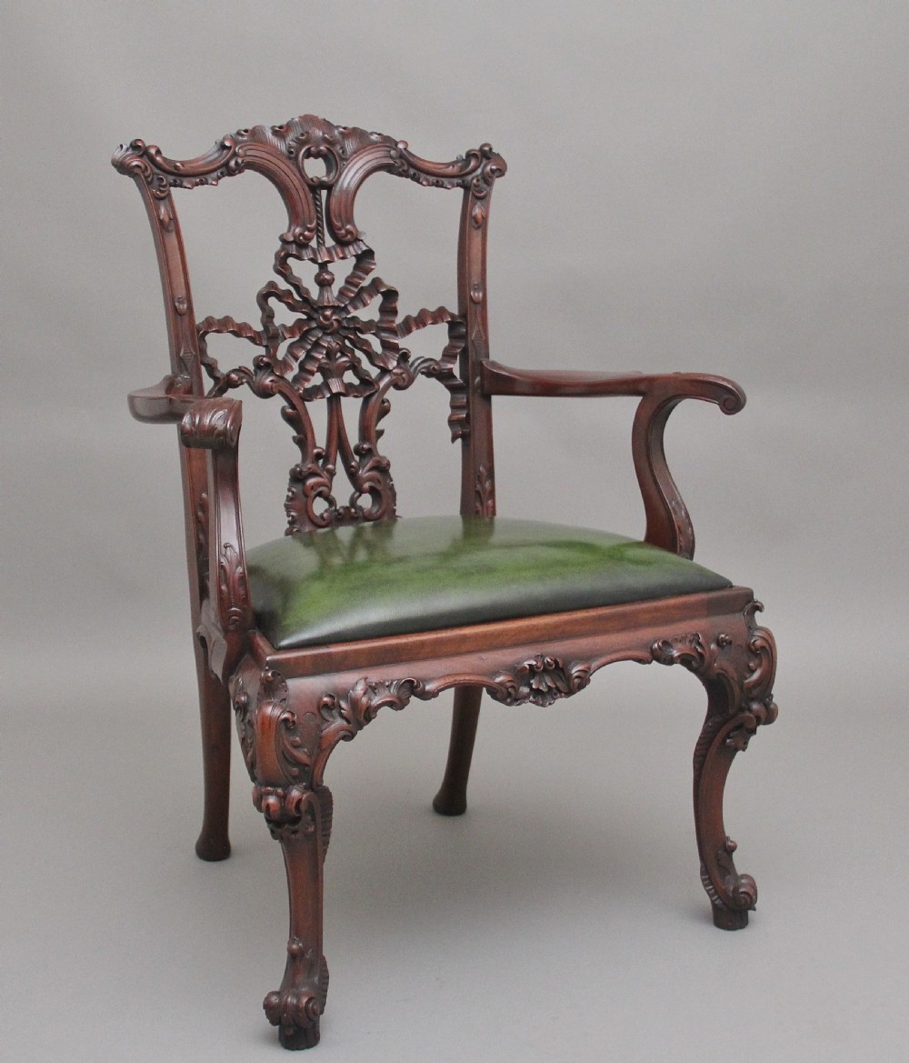 A highly decorative early 20th Century carved mahogany armchair in the Chippendale style