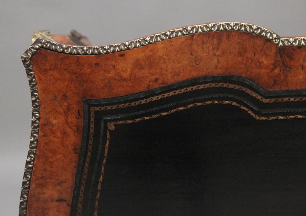 A 19th-century burr walnut bureau plat writing table with decorative gilt-bronze mounts, cabriole legs, and a dark leather inset top. View IX